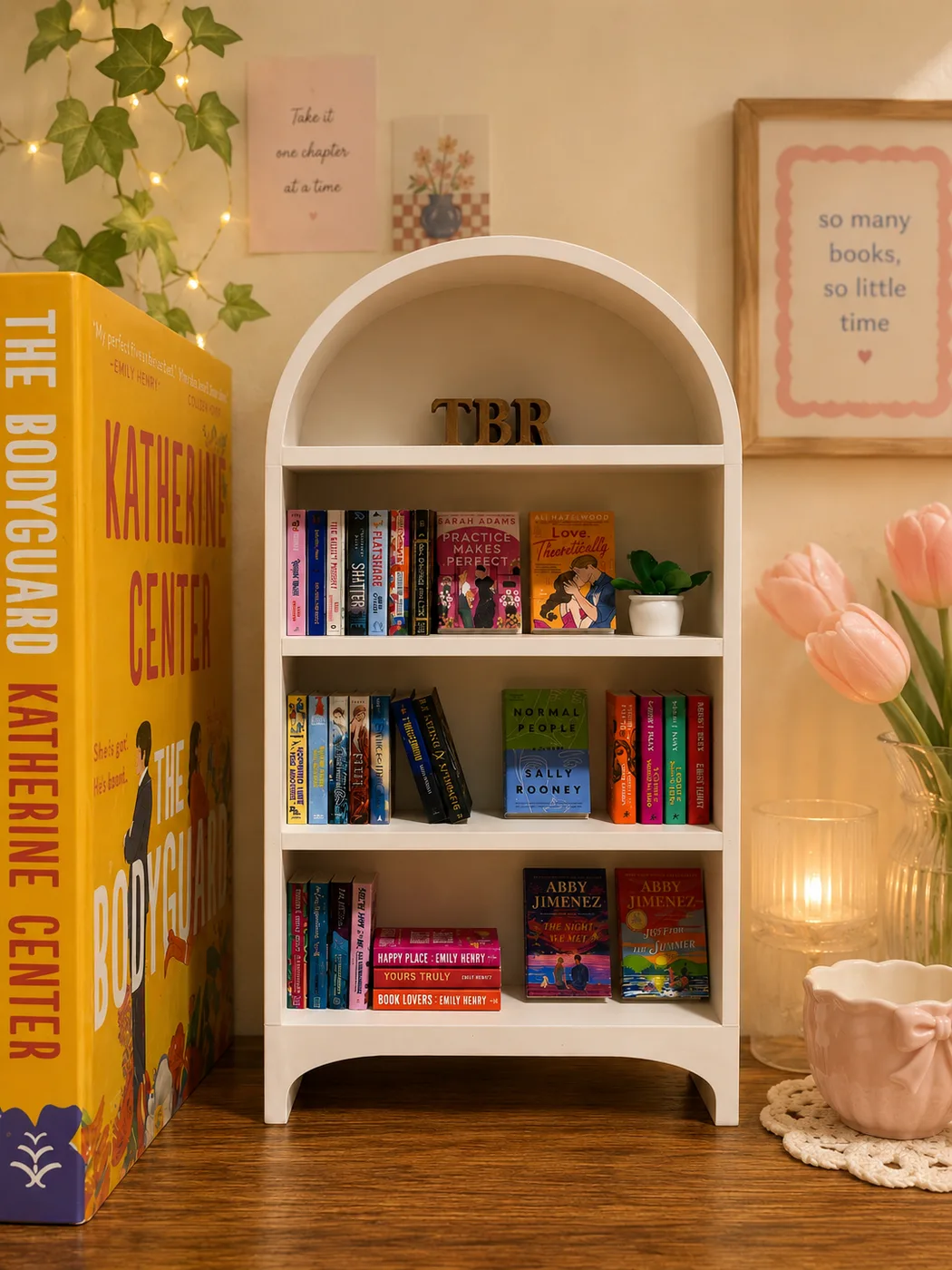 The Bone White Arched bookshelf styled with a TBR topper, fairy lights and tulips