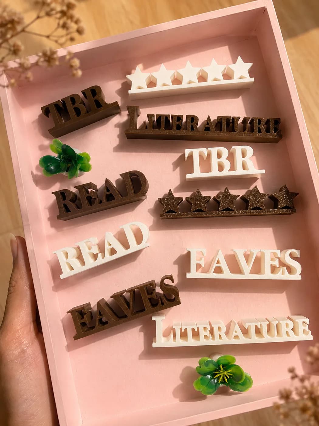 Miniature plants in the accessory tray, alongside the letter blocks and star bars