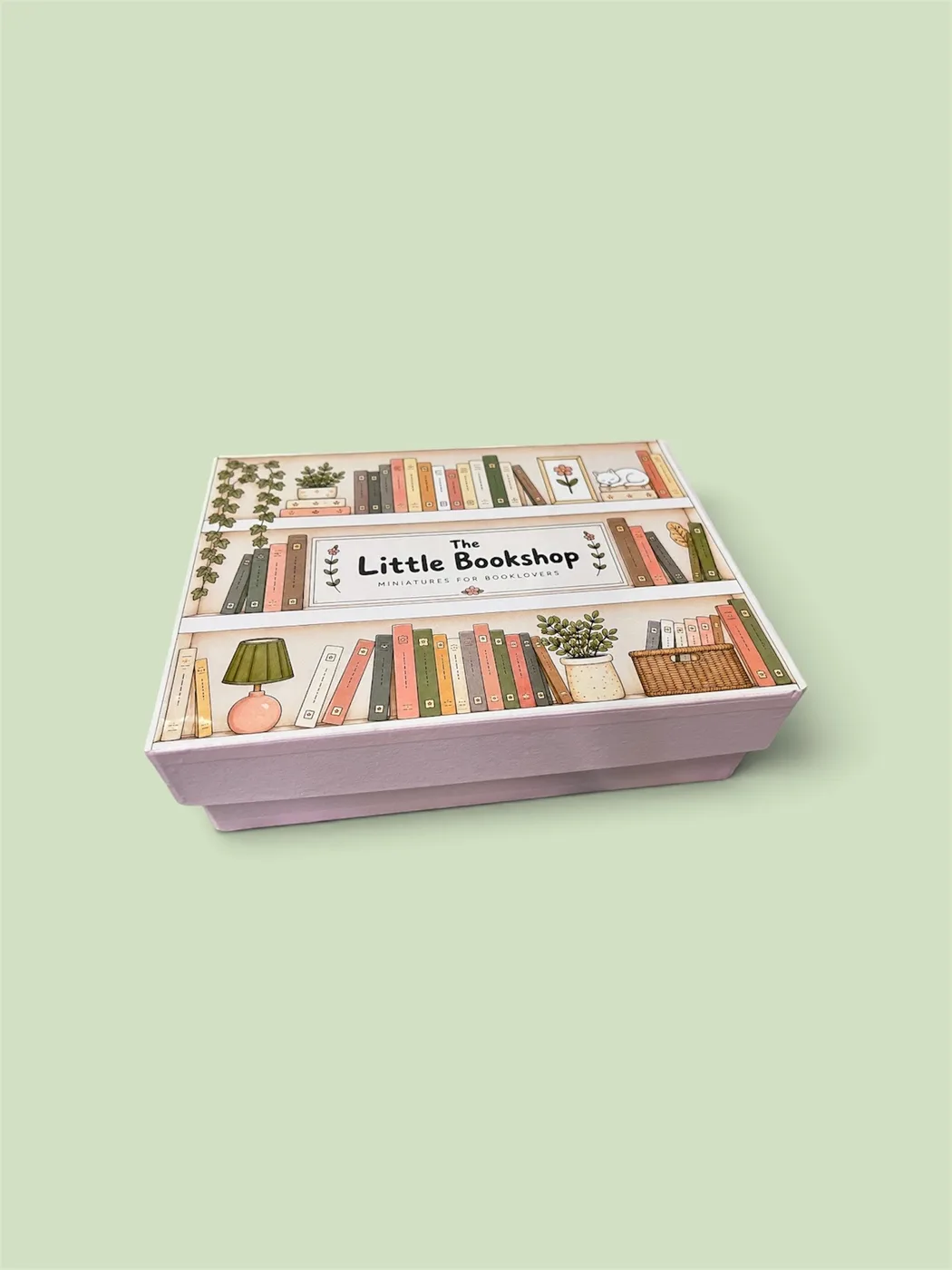 The closed Little Bookshop gift box at an angle, its pastel bookshelf artwork facing the camera