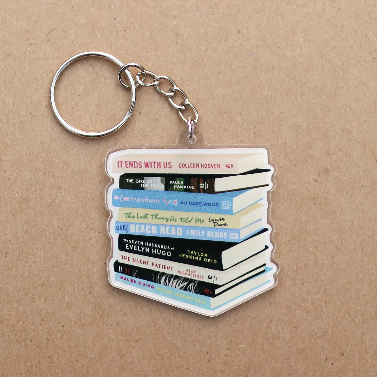 Book stack acrylic keychain laid flat on a kraft background
