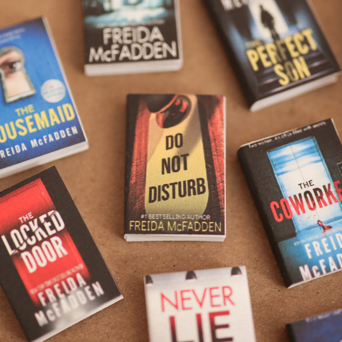 Mini thriller covers spread across a desk, titles clearly readable
